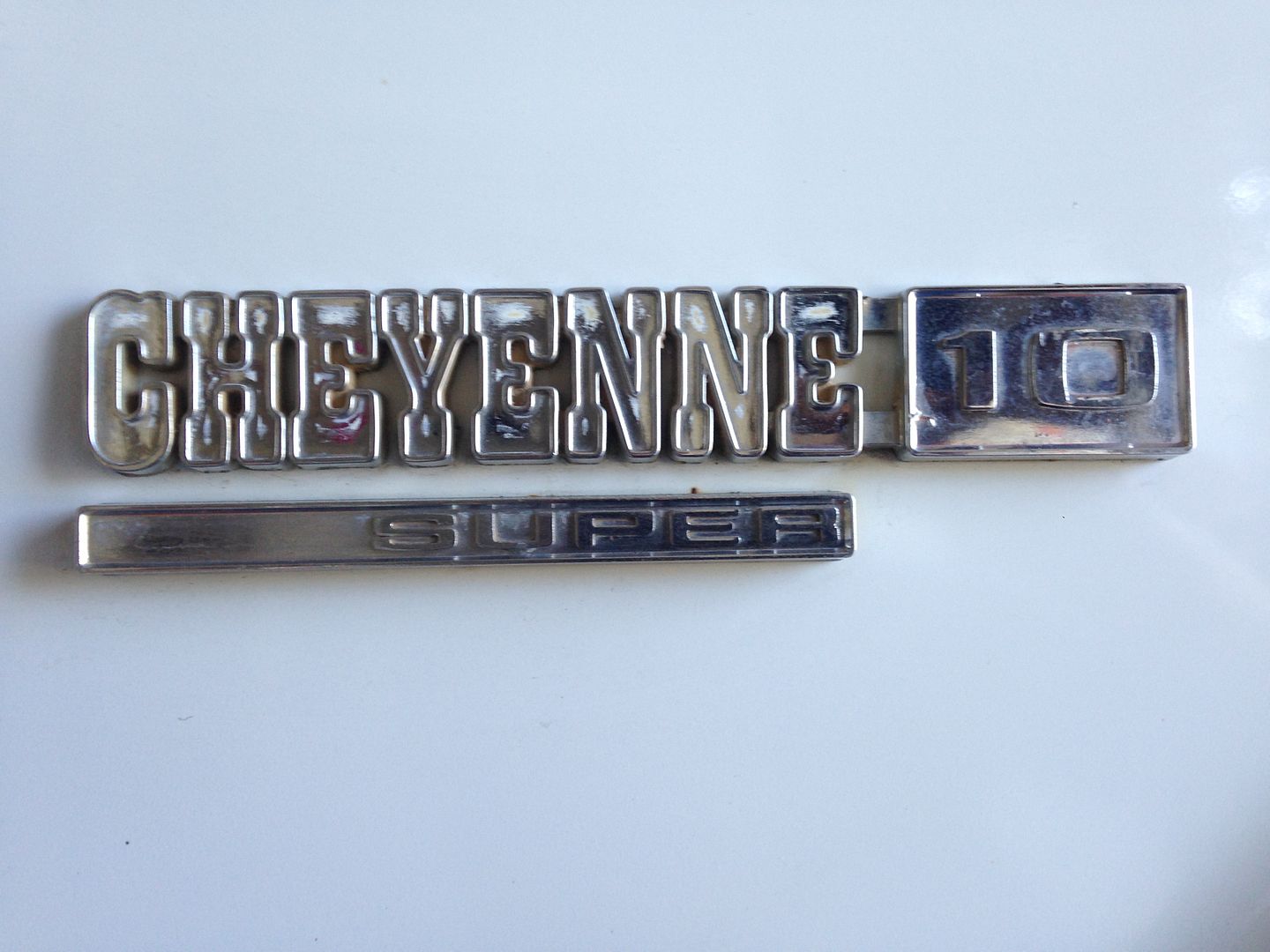 Painting emblems using lacquer paint and a hypodermic syringe The